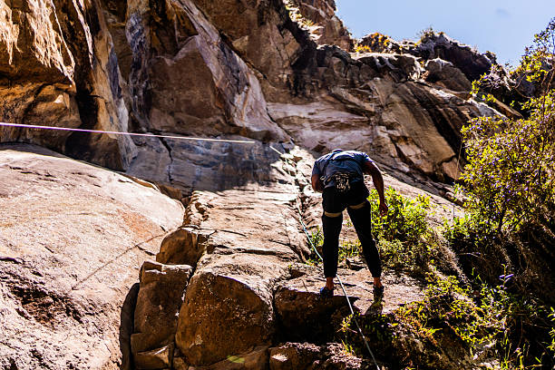Mid adult climber man climbing mountain