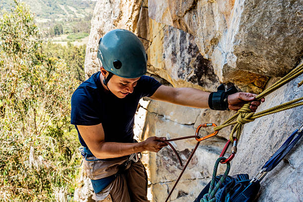 istock Mid adult climber man climbing mountain 2246257576