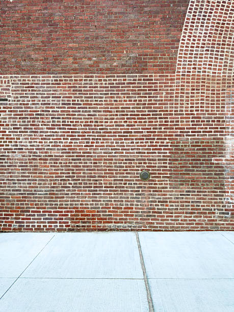 istock Red Brick Wall on a street 2246259864