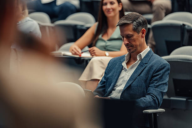 istock Businessman feeling bored during business conference lecture 2246260366