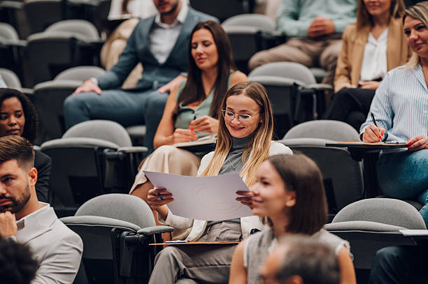 istock Business people sitting in audience at conference 2246260404
