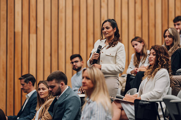 istock Woman asking question during business conference lecture 2246260413