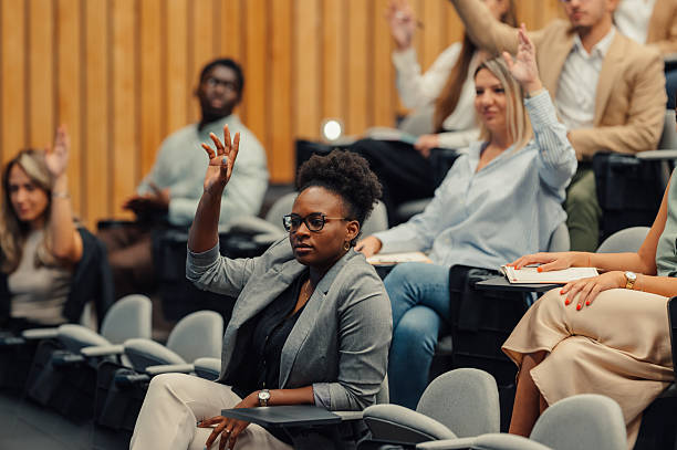 istock Diverse students raising hands asking questions in a lecture 2246260450