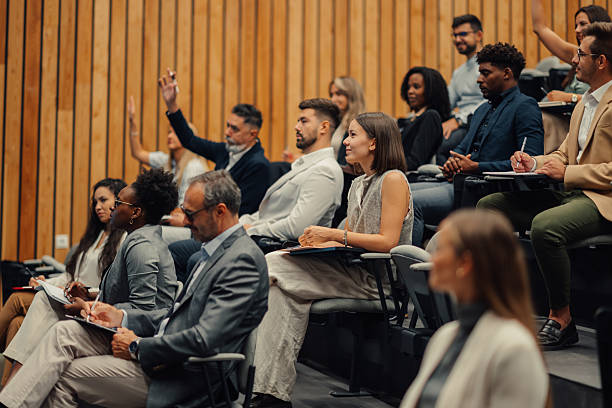 istock Professionals asking questions during business conference presentation 2246260484