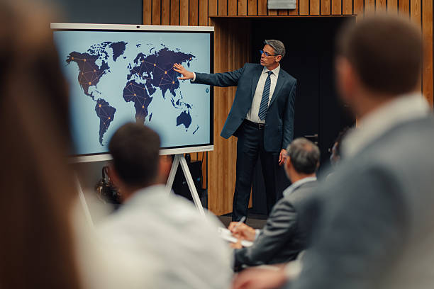 istock Businessman presenting global business strategy with interconnected world map 2246260498
