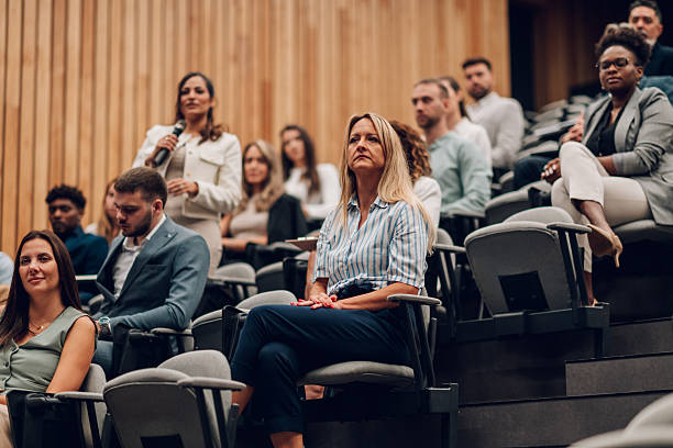 istock Business people attending a conference and asking questions 2246260566