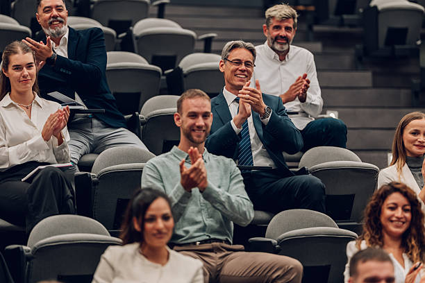 istock Audience clapping, smiling at a business conference seminar 2246260574