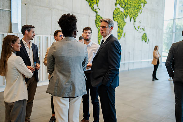 istock Business people networking at international conference with world map 2246260619