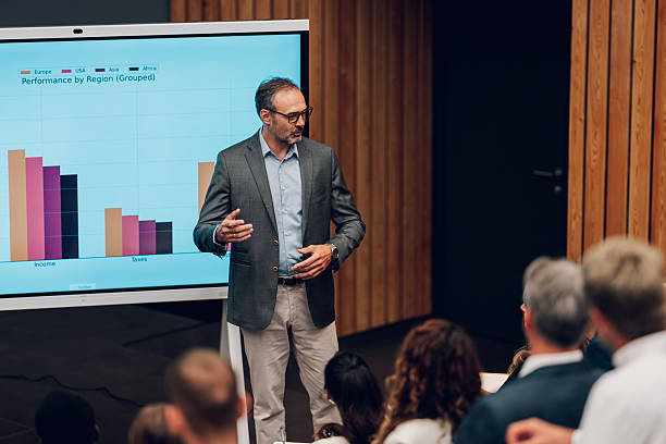 istock Businessman speaking at corporate presentation showing data chart 2246260620