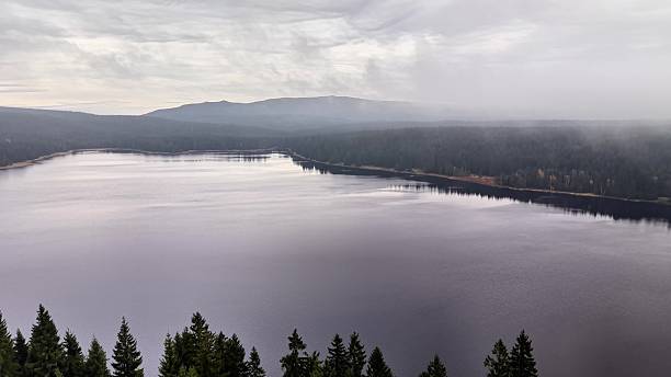 istock tranquil lake amidst scenic highlands, calm water reflecting distant mountain ranges beautifully 2246261101