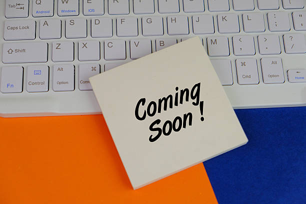 istock Adhesive Note with Text Coming Soon surrounding by colorful office tools, orange and blue background. 2246261118