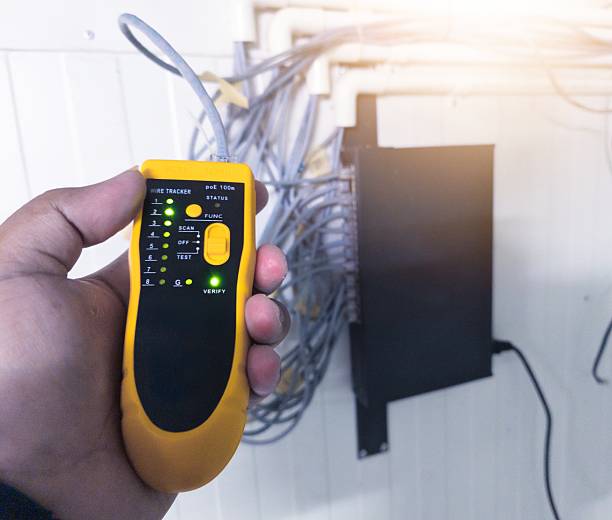 istock Checking RJ 45 cable network connections using a LAN tester, industrial IT support equipment 2246262675