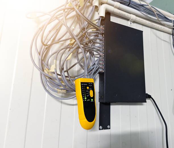 istock Checking RJ 45 cable network connections using a LAN tester, industrial IT support equipment 2246262682