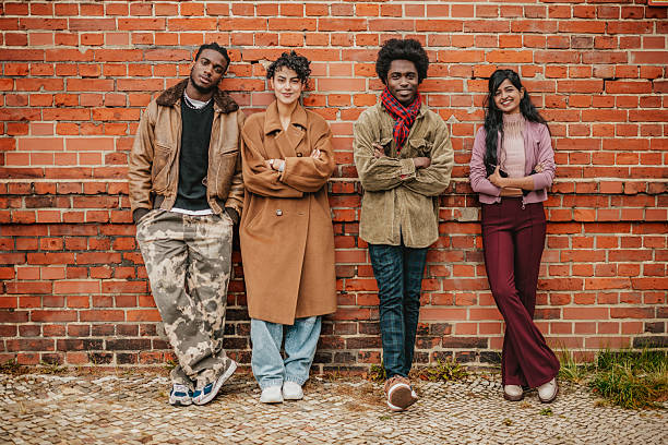 istock Young adults enjoying a fun day out in Berlin against a rustic brick wall with vibrant expressions of joy 2246263917