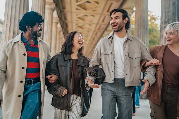 istock Young people enjoy a fun day together in Berlin while walking through a lively street under historic architecture 2246267344