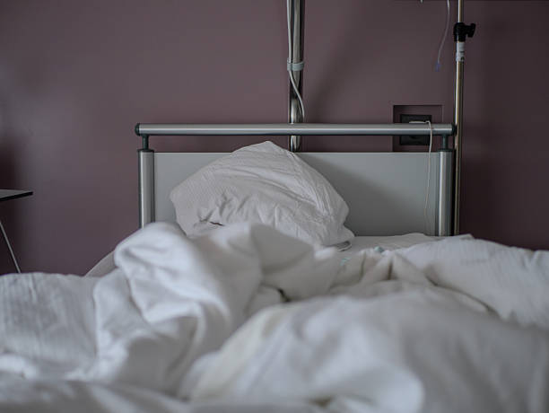 istock Unmade hospital bed with pillow 2246269940