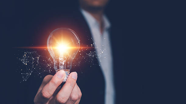 istock Knowledge, innovation and inspiration concept. Businessman hand holding glowing light bulb 2246275371