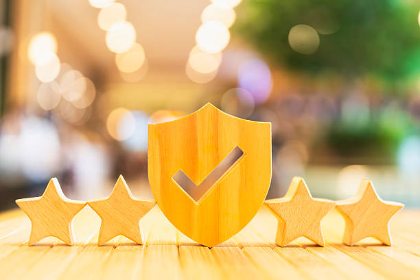 Wooden shield with check mark and five stars representing high quality, trust, customer satisfaction, reliable service, positive review, and secure product or brand assurance.