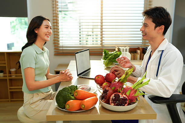 istock Dietician, male nutrition specialist consulting woman, developing healthy diet, dietary program. Dietary consultant asking, giving male patient advice, help, nutritional information, new meal plan 2246278748