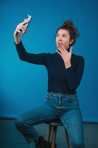 surprised individual captures spontaneous selfie, person surprises themselves with quick selfie shot