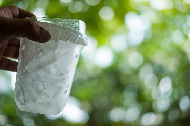 istock Plastic transparent cup of ice drink with lid on hand 2246283451
