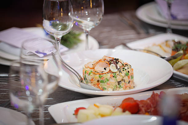 Elegant seafood salad dish on a white plate garnished with vegetables