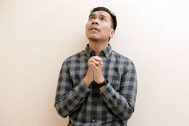 istock A Southeast Asian man looks above, he gesture of hope with a desperate expression 2246287352