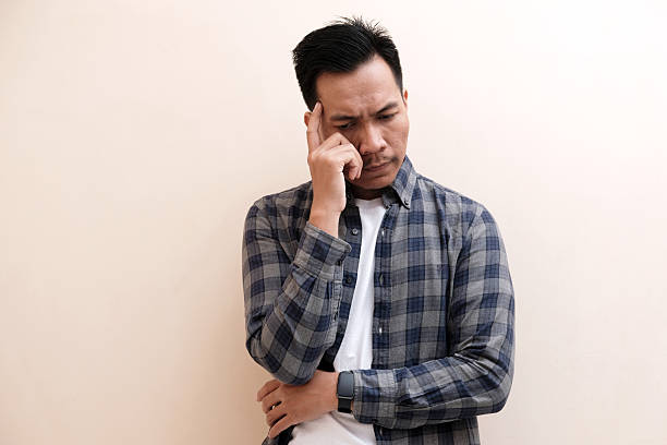 istock Southeast Asian man wearing flannel shirt  thinking about something while looking to upper right corner 2246288282