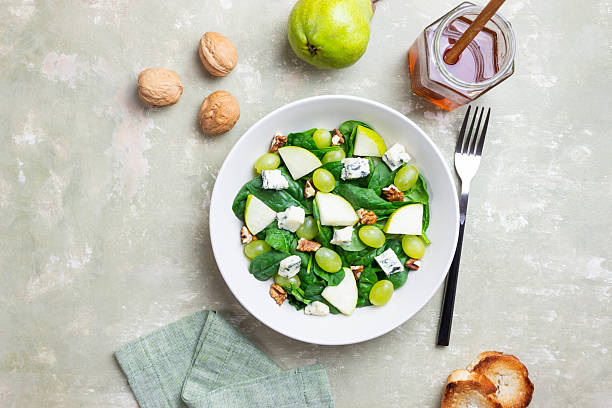istock Salad with spinach, blue cheese, pear, grapes, and nuts. Healthy eating. Vegetarian. 2246288735