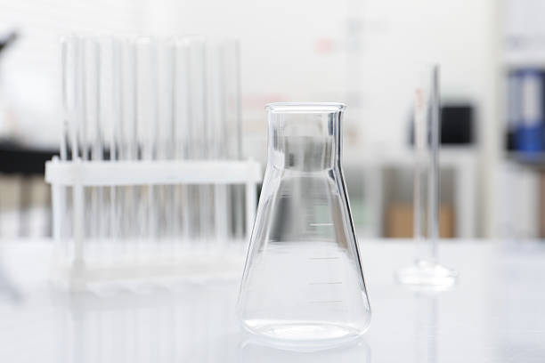 Louisville, CO, USA- February 15, 2025:  Water is placed into a Chemistry Beaker.  A Magnetic Spinner is used to stir the liquid. The clip focuses on the water as it is stirred into a Vortex inside the Beaker. This is a backlit studio scene with copy space on a neutral background.