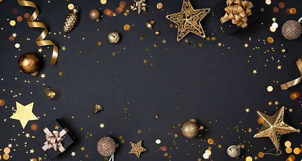istock Christmas decoration objects on black background top view with holiday ornament and copy space in center 2246289634