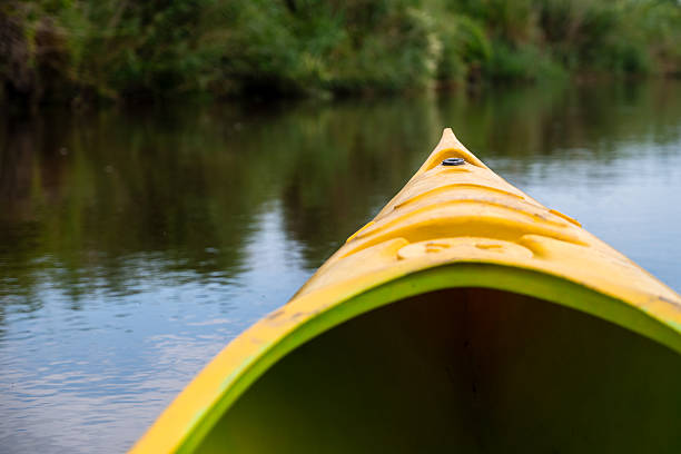 istock yellow kayak on a river - summer daytrip adventure 2246293204