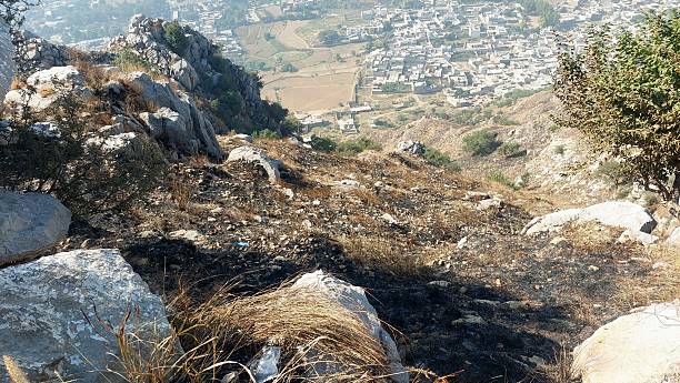 istock Rugged Rocky Hillside Overlooking Sprawling Valley Settlement 2246294279