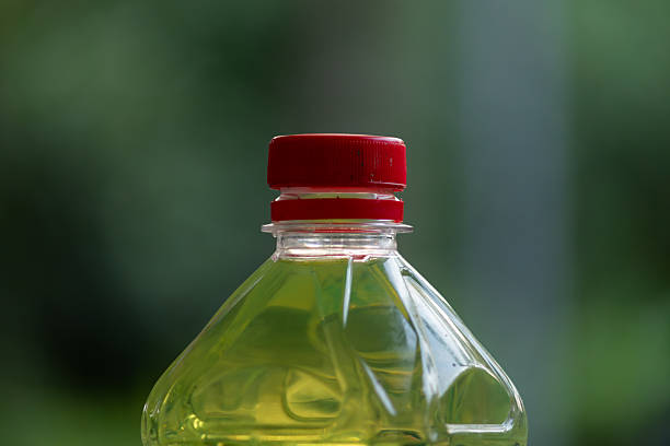 Plastic bottle with red cap on green bokeh background