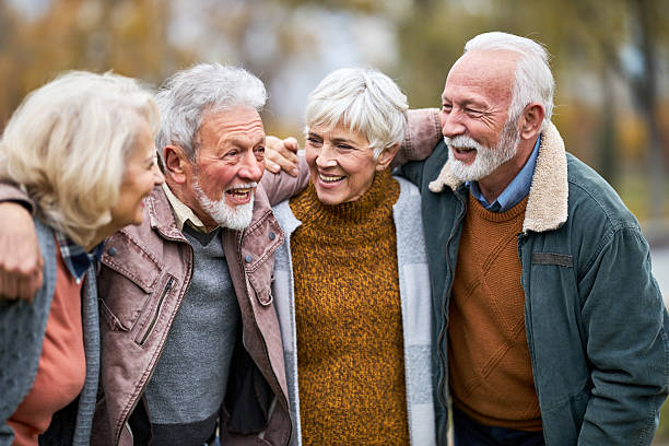 istock Cheerful senior friends talking embraced in nature. 2246294675
