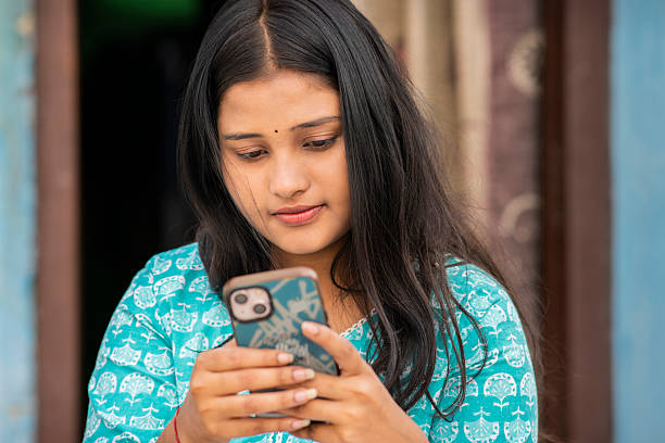 istock Happy Indian young woman using a smartphone. 2246296162