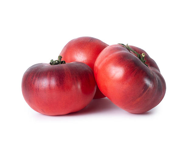 istock Organic dark red tomatoes close up on a white background 2246296722