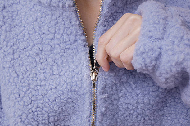 istock Woman unzips her purple sherpa sweatshirt. 2246297815