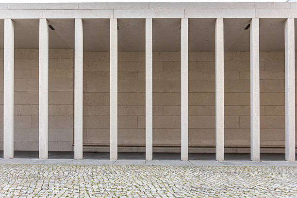 Modern facade with vertical fins and cobblestone, clean geometry. Minimalism.