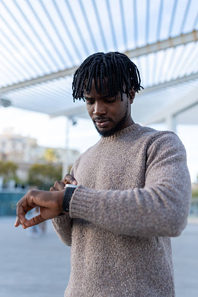 istock Young black man checking smartwatch for time 2246298166
