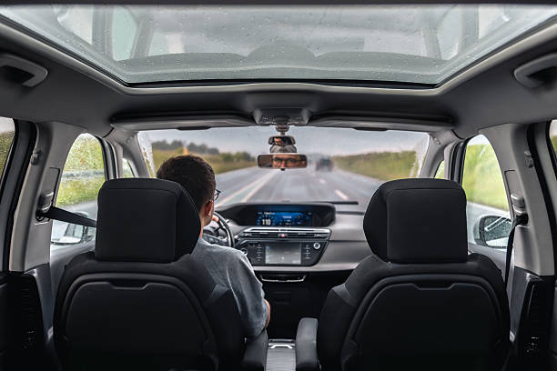istock Driver on rainy road trip. Autumn day behind the wheel. 2246298280