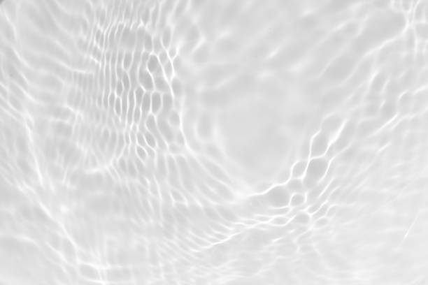 istock White water with ripples on the surface. Defocus blurred transparent white colored clear calm water surface texture with splashes and bubbles. Water waves with shining pattern texture background. 2246299662