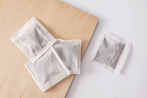 istock Herbal tea bags on wooden board. White background 2246299685