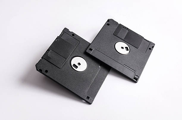 istock Two black 3.5 inch floppy disks isolated on white background 2246299752
