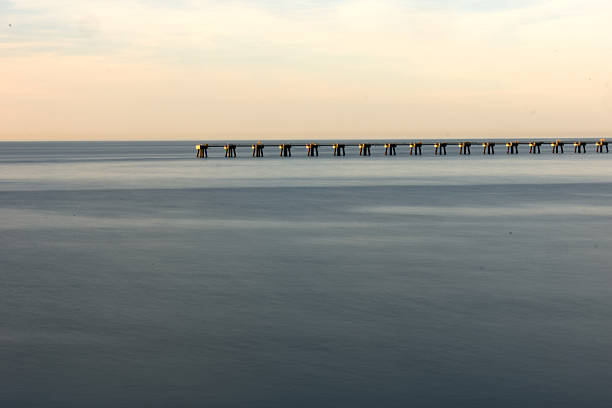 istock Rhythmic Sequence of Pier Pylons on the Sea Horizon 2246300269