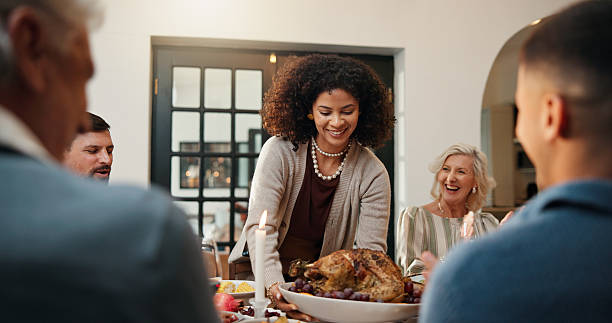 istock Serving, family dinner and woman with turkey at table, applause and bonding event in thanksgiving feast. Clap, hosting and group of people in dining room for meal, holiday reunion and happy gathering 2246301607