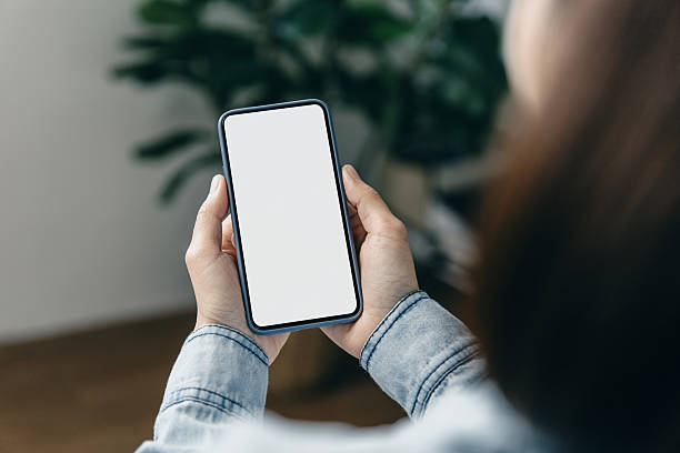 istock Woman holding smartphone with an empty white screen, ready for design, advert. 2246301874
