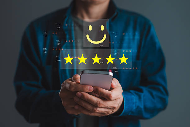 istock Man using smartphone with five-star rating and review data for positive customer feedback, online reputation, and digital satisfaction tracking 2246301979
