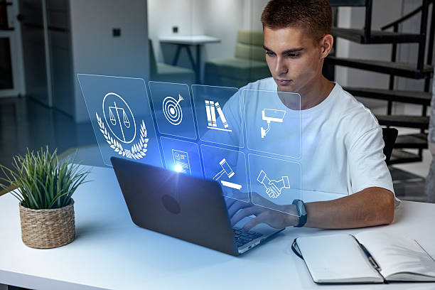 istock Young man working on laptop with holographic screen in modern workspace setting 2246303816