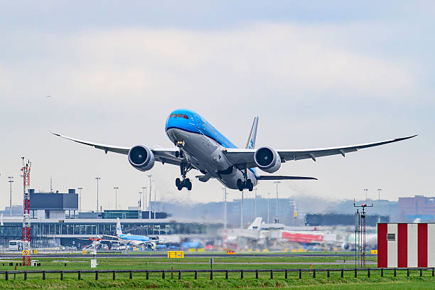 KLM Boeing 787 Dreamliner airplane taking off from Schiphol airport on the Kaagbaan. KLM stands for Koninklijke Luchtvaart Maatschappij, Royal Dutch Airlines and is part of Air France–KLM. The Boeing 787 alos called Dreamliner is a wide-body jet airliner by American manufacturer Boeing Commercial Airplanes. Schiphol is one of the busiest and largest airports in Europe, located near Amsterdam, Netherlands. It serves as a major hub for international flights and is a key gateway to Europe.